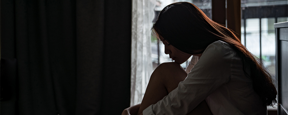 Girl in dark room on floor